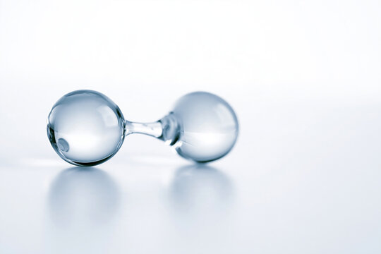 Two water molecules linked by a hydrogen bond on white, molecular bonding concept