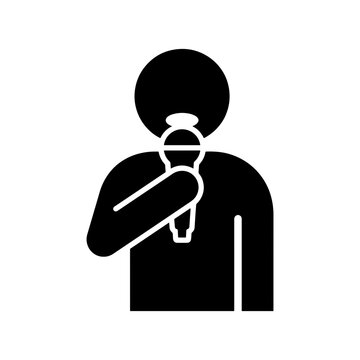 A minimalist black and white vector glyph icon depicting a person holding a microphone, perfect for public speaking, podcasting, singing, and broadcasting concepts.