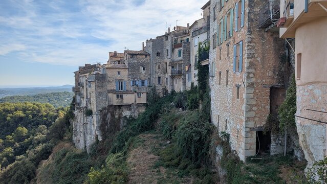 Old stone houses built on a rocky cliff in Tourrettes sur Loup, France. 