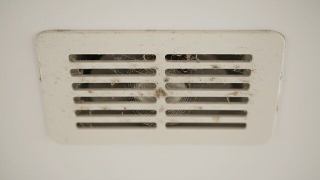 Dirty Ventilation Grill Covered with Dust and Spider Webs