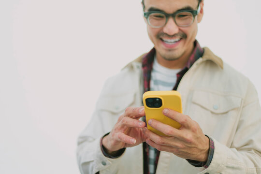 man using mobile phone holding cell phone texting message contact us.chatting,search internet shopping online.device communication connecting