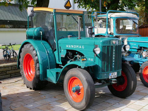 Germany, H&ouml;velhof, October 03. 2026, An oblique view of a restored Hanomag R 45 (or R 45 S) vintage tractor in striking dark green with red rims
