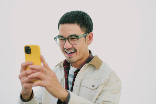 man using mobile phone holding cell phone texting message contact us.chatting,search internet shopping online.device communication connecting