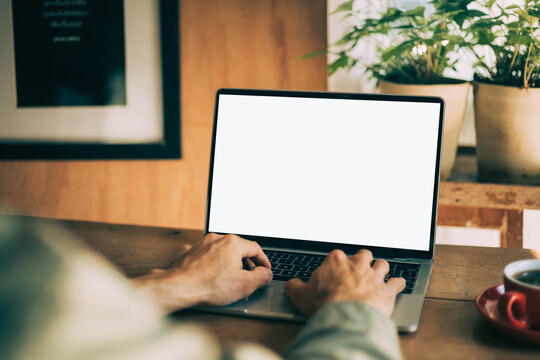 computer screen blank mockup.work using laptop with white background for advertising,contact business search information on desk at coffee shop.marketing and creative design