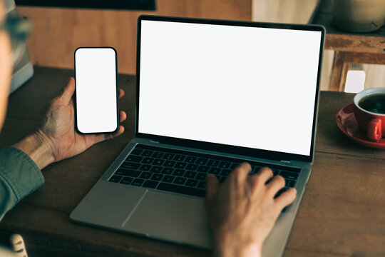 computer screen,mobile phone blank mockup.work using laptop texting cell phone.white background for advertising,contact business search information on desk.marketing,design