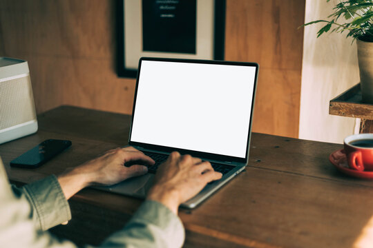 computer screen blank mockup.work using laptop with white background for advertising,contact business search information on desk at coffee shop.marketing and creative design