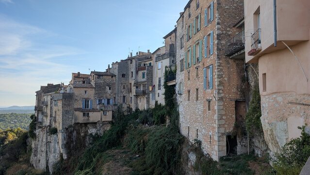 Old stone houses built on a rocky cliff in Tourrettes sur Loup, France. 