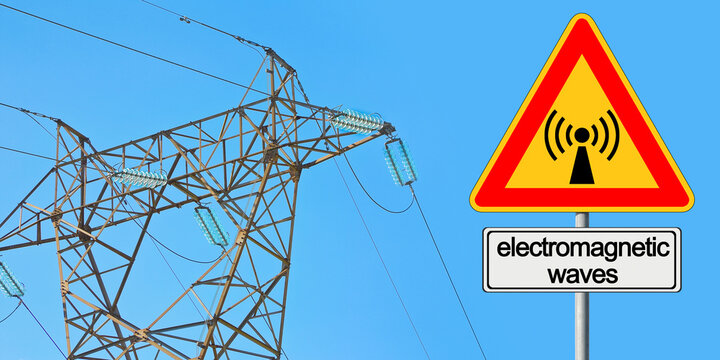 ALERT ABOUT ELECTROMAGNETIC POLLUTION EXPOSURE IN A RESIDENTIAL AREA - Concept with electricity pylon, power tower, transmission lines and electromagnetic emissions fields with placard
