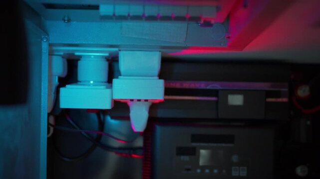 Smart sockets inverter and battery banks connected by power cables in a home energy room with glowing charge indicators. Concept of intelligent home power management and backup energy system