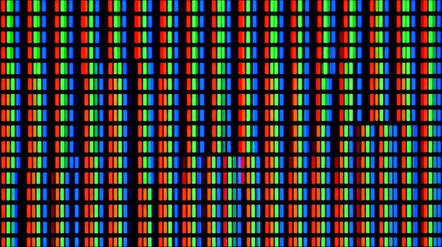 Extreme macro view showing vibrant red green blue pixels display