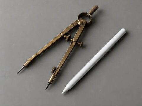 Vintage brass drafting compass set lies next to modern digital