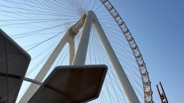 Close Up View of Ain Dubai Observation Wheel Against Blue Sky. Concept of modern engineering landmarks, tourist attractions, and UAE leisure travel.