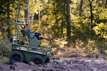 Fototapeta premium Military robot with machine gun patrolling forest environment