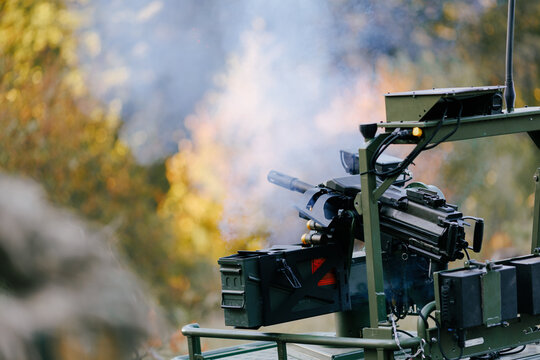 Remote weapon station firing machine gun during military exercise