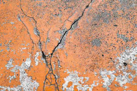 Cracked Cement Surface with Peeling Orange Paint.