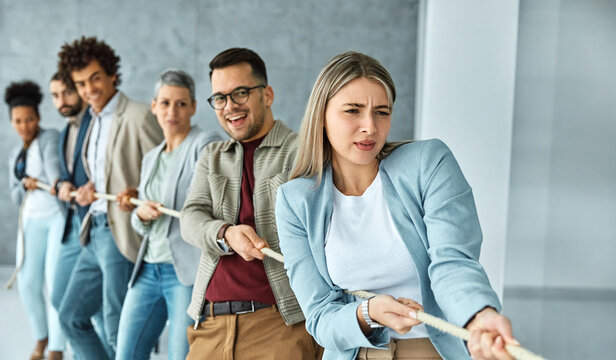 Portrait of a young  businesspeople pulling a rope in the office