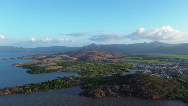 AERIAL DRONE VIEW COASTLINE MANGROVES AND MOUNTAINS IN BIMA, INDONESIA