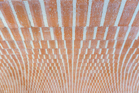 Geometric pattern with many orange bricks and white mortar lines