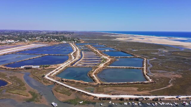 Scenic aerial view of the traditional salt pans and evaporation ponds for sea salt production in fuseta, located within the beautiful ria formosa natural park in the algarve region of portugal