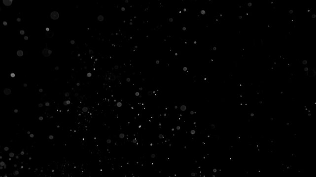 Cinematic stock video overlay featuring floating dust particles, lens flare bokeh circles, and soft light specks drifting against a solid black background