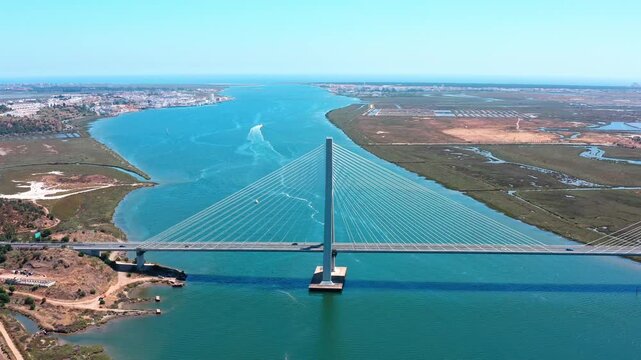 Aerial view of the guadiana international bridge, a cable stayed bridge spanning the guadiana river and connecting the algarve region of portugal with andalusia in southern spain