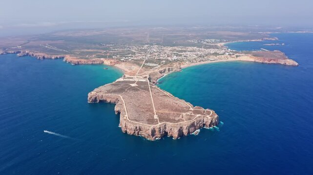 Aerial view of the historic sagres fortress and promontory, a famous landmark surrounded by the deep blue atlantic ocean and the beautiful coastline of the algarve region in portugal