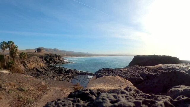 Rocky volcanic coastline of Playa del Castillo, Island Fuerteventura, Canary Islands, Spain, Europe. Stunning panoramic view of the Atlantic Ocean from the volcanic coast of Fuerteventura, Canary Isla