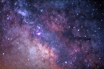 Colorful Milky Way galaxy with purple and pink nebulae and dense star field in deep space © liangfu