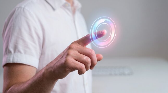 A man in a white shirt touches a glowing colorful virtual holographic button in a modern office