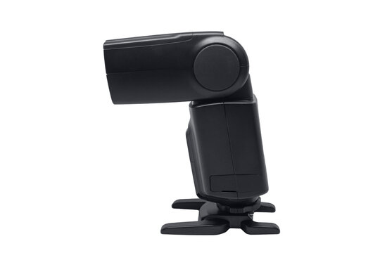 A side view of a black external camera flash speedlight mounted on a hot shoe stand isolated