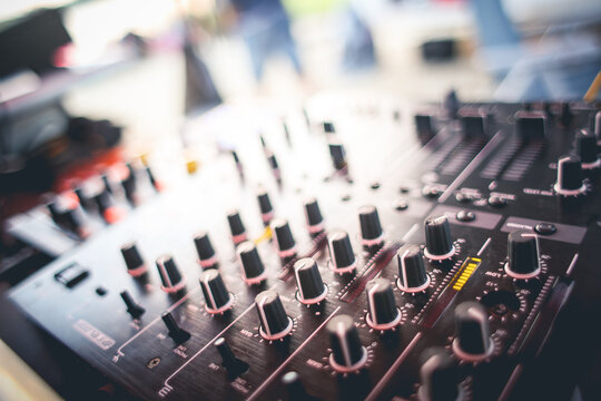 Professional audio mixing console with knobs and faders