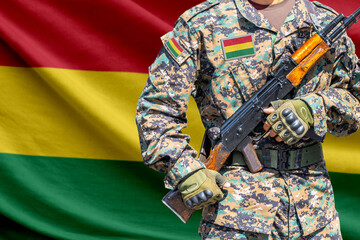 Fototapeta premium Bolivia flag with soldier in military uniform holding assault rifle in front of it