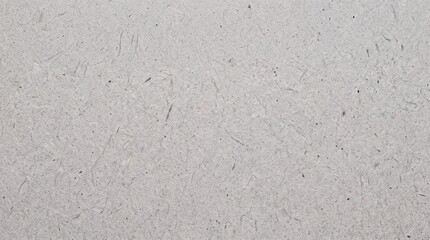 Fototapeta premium Full frame close-up of high resolution gray recycled handmade paper texture with visible organic fibers and natural flecks, perfect for eco-friendly design and artisan craft backgrounds.