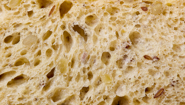 Whole grain artisan sourdough bread crumb with seeds. Macro shot. Close up. Copy space. Top view.