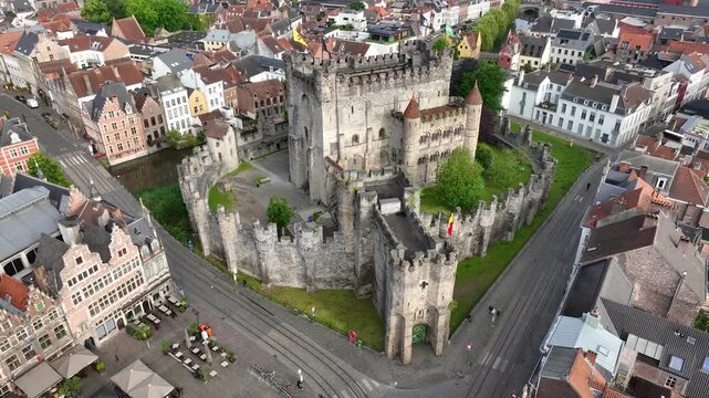 Aerial view of Ghent, Belgium, featuring the medieval Gravensteen Castle surrounded by historic architecture, canals and charming streets in the heart of the old city.