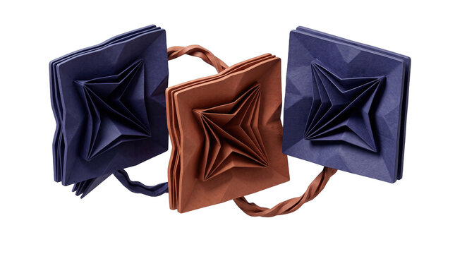 Three decorative square paper origami ornaments in blue and brown connected by twisted paper ribbons on black