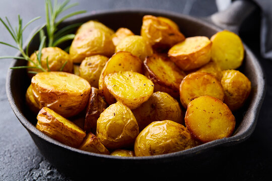 Baked potato halves garnished with herbs. Close up.