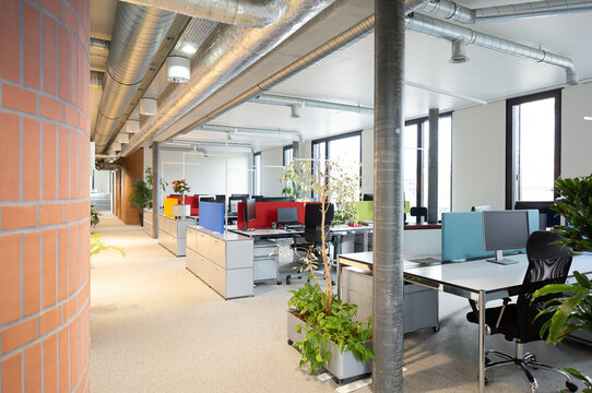 Modern coworking office interior with colorful workstation design