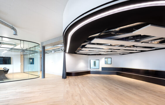 Modern office interior with curved ceiling and open workspace