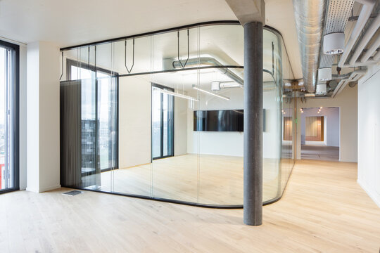 Modern coworking office interior with curved glass partition
