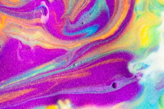Vibrant fluid art texture with swirling colorful pigments