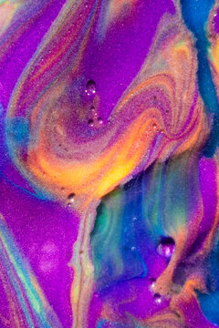 Vibrant abstract fluid paint texture with neon color swirls