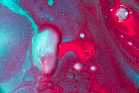 Abstract turquoise and magenta liquid paint texture background