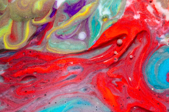 Vibrant red and turquoise fluid paint abstract background
