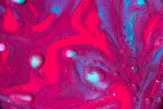 Vibrant pink and turquoise liquid marble abstract background
