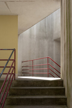 Red railings and concrete stairs in modern architecture