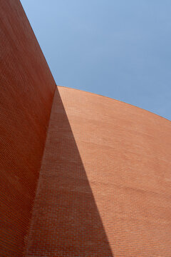 Red brick walls against clear blue sky
