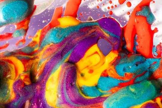 Vibrant macro of colorful paint swirl and bubble texture