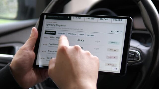 Executive reviews corporate spending requests on a tablet, showing digital budget approval, financial control and faster decision making in modern business management.
