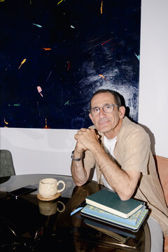 Portrait Senior man relaxing at dining table with coffee, books